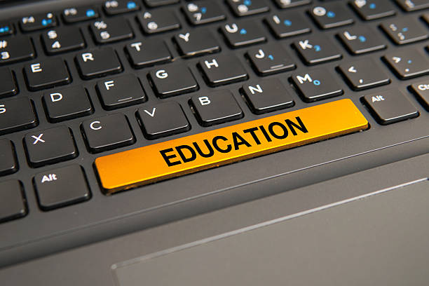c4 Close up of a computer keyboard with a yellow education key, representing learning, knowledge acquisition, online education, academic development, and lifelong learning concepts.