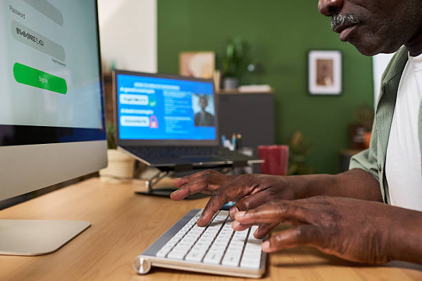 c6 Close up of African American senior man and Caucasian middle aged woman learning online at home, using computer and laptop. Supporting digital skills training, lifelong education marketing