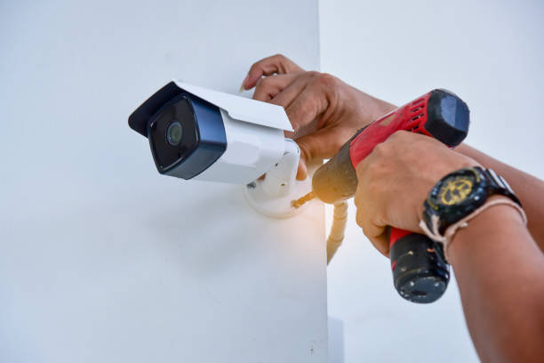 Technician installing CCTV camera for security Technician installing CCTV camera for security