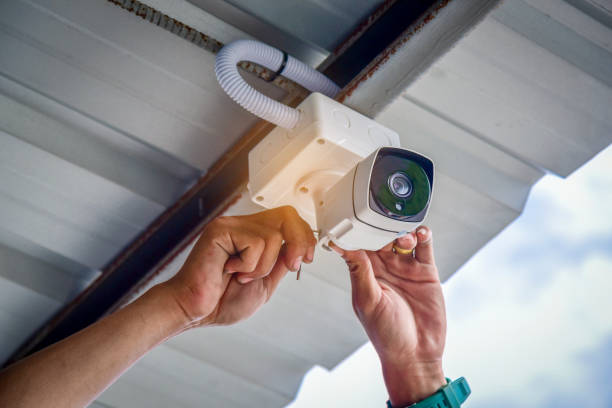 Technician installing CCTV camera for security Technician installing CCTV camera for security