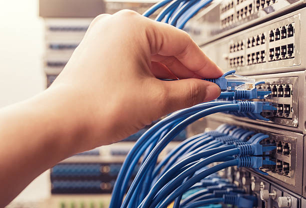 plugging network cables into a high end switch. plugging network cables into a high end switch.