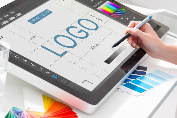 Graphic designer at work. Color swatch samples. NOTE TO INSPECTOR: All visible photos were produced for this particular shoot. I am the author of everything that you see in the image (interface program on the screen - property release added).