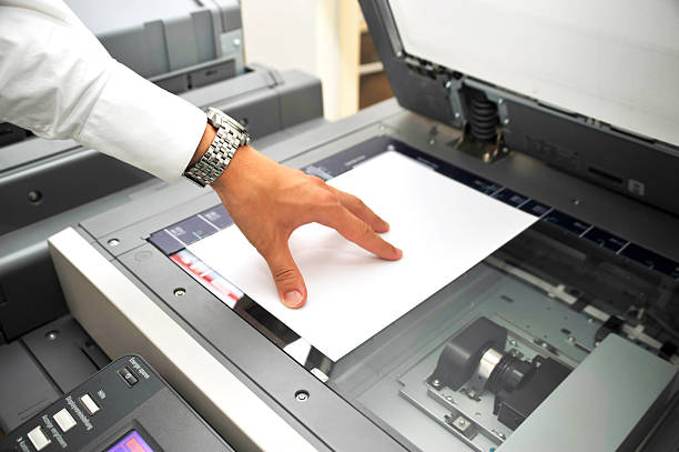 human hand using copier. Close-up picture with bright light human hand using copier. Close-up picture with bright light
