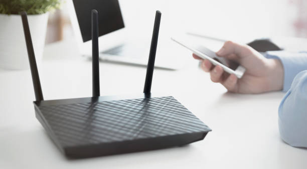 Wireless router or access point. Man using smartphone Wireless router or access point. Man using smartphone